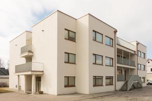 a large white building with a lot of windows at RG Kanali Apartment in Pärnu