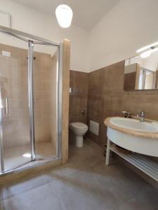 a bathroom with a shower and a sink and a toilet at Casa Ciclamino in San Vito lo Capo