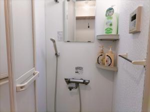 Baño blanco con aseo y puerta en Nishi-ogikubo, en Ogikubo