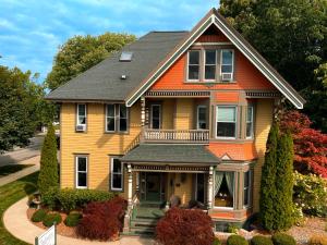 a yellow and orange house with a black roof at The Ludington House in Ludington