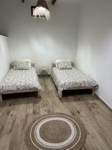 2 letti in una camera con tappeto sul pavimento di Villa Ocean Breeze a Firgas