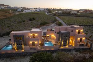 an aerial view of a villa with a sunset at Golden moments Luxury Stone Villas A in Mesaria