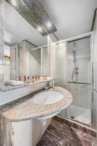 a bathroom with a sink and a shower at Le COQ Tersling - Residential Parking - AC - Sea view in Menton +26 photos