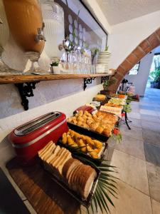 a buffet with bread and pastries on a table at Pousada Villegaignon in Búzios