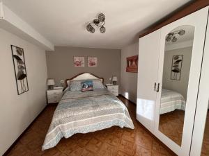 a bedroom with a bed with a bedspread on it at Casa Casal de Can in Carballo
