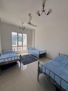 Posteľ alebo postele v izbe v ubytovaní Oman Hostel