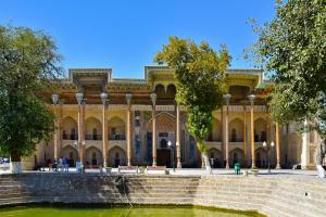 a large building with a pond in front of it at Al-Khabib in Bukhara