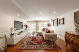 a living room with a couch and a tv at Lisbon Rentals Chiado in Lisbon