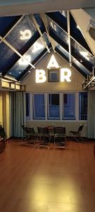 a room with chairs and a sign that reads bryan at ROSE HOSTEL DALAT in Da Lat