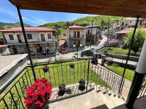 a balcony with a view of a town with houses at Rustic House in Miléa