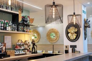 a restaurant with a bar with a clock on the wall at Hotel Ecos del Sella in Cangas de Onís