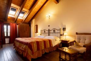 a bedroom with a large bed and a chair at Locanda Del Mulino in Maranello