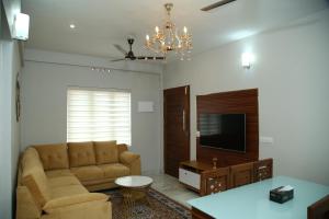 a living room with a couch and a tv at 88 homes kochi in Ernakulam