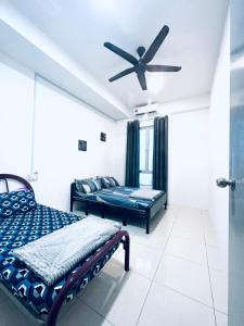 a bedroom with two beds and a ceiling fan at Khalish Homestay Pokok Sena in Pokok Sena +8 photos