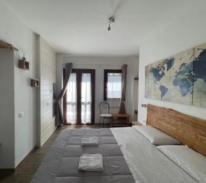 a bedroom with a large bed and a large map on the wall at Residenza di Campagna Dolmen Motorra in Dorgali