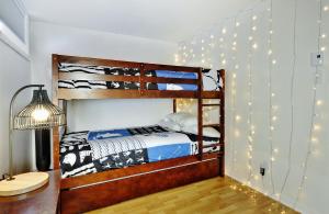a bedroom with two bunk beds with lights on the wall at 51 Chemin de la Corniche in Stoneham