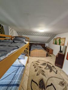 a bedroom with two bunk beds and a rug at La Popica in Tîrnăveni