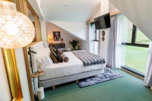 a bedroom with a bed and a large window at Hotel Ecos del Sella in Cangas de Onís