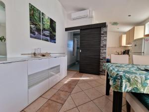 a kitchen with white cabinets and a counter top at Paradise in Pula
