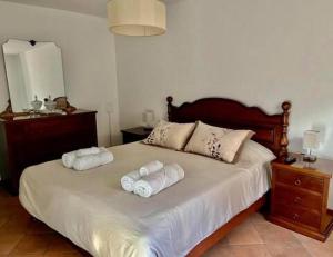 a bedroom with a bed with three towels on it at Palazzo Mane in CastellʼArquato