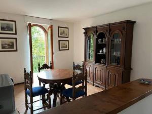 a dining room with a wooden table and chairs at Palazzo Mane in CastellʼArquato +10 photos