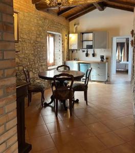 a kitchen and dining room with a table and chairs at Palazzo Mane in CastellʼArquato