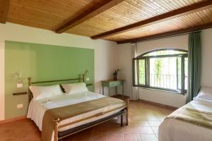 a bedroom with two beds and a window at Ca' Nadin Agriturismo in San Damiano dʼAsti
