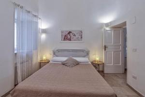 Postel nebo postele na pokoji v ubytování Trulli Elios