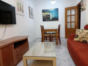 a living room with a couch and a table at Apartamento Candari Playa en Cadiz in Cádiz