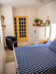 a bedroom with a bed and a chair in it at Maison Chevalier in Narbonne