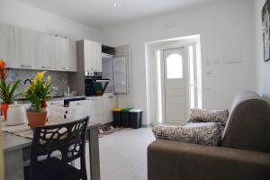 a kitchen and living room with a couch and a table at RESIDENCE CIMINO emozioni mediterranee in Scanzano +40 photos