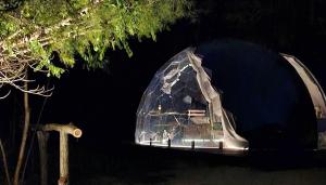 a glass dome is lit up at night at Camping Paradiso in Pesaro