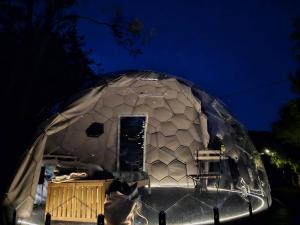 a large dome tent with a door in it at night at Camping Paradiso in Pesaro