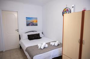 a bedroom with a bed with two pillows on it at Studio in Corfu in Kanálion