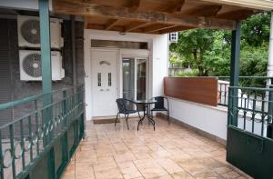 a patio with two chairs and a table on a porch at Studio in Corfu in Kanálion