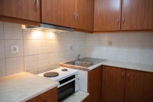 a small kitchen with a sink and a stove at Studio in Corfu in Kanálion +3 photos