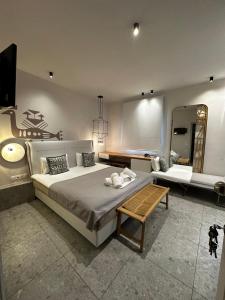a bedroom with a large bed and a mirror at Egeo in Limenas