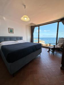 1 dormitorio con 1 cama y vistas al océano en B&B Chianalea 54, en Scilla