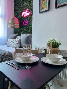 a purple table with two plates and glasses on it at J&W Apartments with free parking in Liverpool