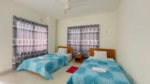 Postel nebo postele na pokoji v ubytování Hotel Stay Inn Uttara