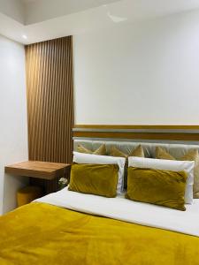 Golfview luxury apartment في خليج ريتشاردز: غرفة نوم بسرير ذو أغطية ومخدات صفراء