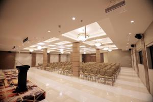 a large room with chairs and a podium in it at Utham Mahal in Anchal