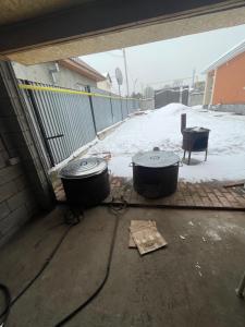 two large drums sitting on the floor of a garage at Гостевой дом in Pokrovka