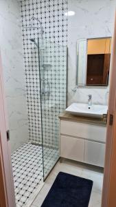 a bathroom with a glass shower and a sink at SkyWay Twins Studio Gudauri in Gudauri +23 photos
