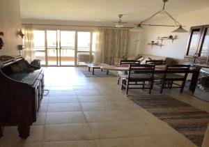 a living room with a couch and a table at Sidi Abdel Rahman Blumar 1st Floor Chalet in El Alamein