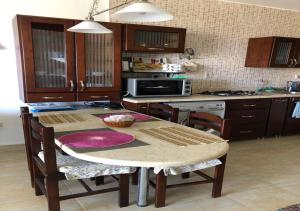 a kitchen with a table with chairs and a kitchen with a stove at Sidi Abdel Rahman Blumar 1st Floor Chalet in El Alamein