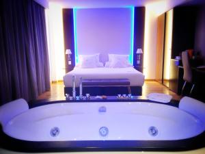 a room with a bath tub and a bed at MB Boutique Hotel - Adults Recommended in Nerja