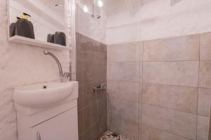 a bathroom with a sink and a shower at Das Hotel Alacati in Alaçatı