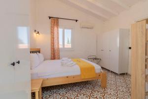 a small bedroom with a bed and a window at Das Hotel Alacati in Alaçatı