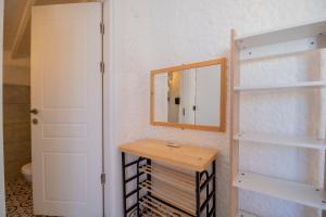 a bathroom with a mirror and a wooden table at Das Hotel Alacati in Alaçatı